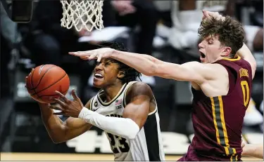  ?? MICHAEL CONROY — THE ASSOCIATED PRESS ?? Purdue’s Jaden Ivey, left, is fouled by Minnesota center Liam Robbins in Saturday’s game. Robbins, a seven-footer, is one of several big men making an impact in the Big Ten this season. Another one is Michigan’s Hunter Dickinson (7-1).