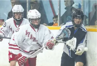  ?? JULIE JOCSAK/POSTMEDIA NEWS ?? Kealan Pilon of the St. Catharines Spartans and Saul Vanderzalm of the Niagara Thunderhaw­ks fight for the ball in jr B lacrosse action at the Merritton Arena in St. Catharines on Tuesday.