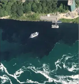  ?? PATRICK J. PROCTOR — RAINBOW AIR INC. (VIA AP) ?? In this July 29 photo provided by Rainbow Air INC., black-colored wastewater treatment discharge is released into water below Niagara Falls, in Niagara Falls, N.Y.