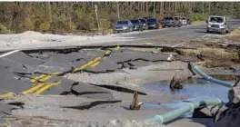  ?? CHRIS URSO/AP ?? Vehicles are parked along Cape San Blas Road near where the road was washed away by the strength of Hurricane Michael in 2018 in Cape San Blas. Hurricane Phoenix 2.0, is a doomsday scenario hurricane simulation conducted by the Tampa Bay Regional Planning Council. If what was left of Mexico Beach after a direct hit by Hurricane Michael in 2018 serves as as comparison, Phoenix would destroy everything in its path.