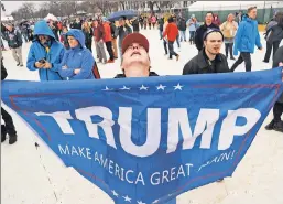  ??  ?? Things are looking up: One of many Trump supporters on the National Mall Friday reacts to the new president’s inaugurati­on in Washington, DC.