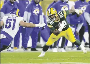  ?? PHOTO/ MATT LUDTKE
AP ?? Green Bay Packers’ AJ Dillon tries to run past Los Angeles Rams’ Troy Reeder during the second half of an NFL football game Sunday in Green Bay, Wis.