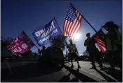  ?? ASHLEY LANDIS — THE ASSOCIATED PRESS ?? People attend a rally in support of President Donald Trump outside Thousand Oaks City Hall on Wednesday.