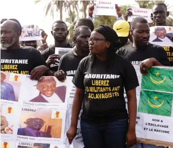  ??  ?? Senegalese anti-slavery protesters rally against the imprisonme­nt of fellow activists in neighbouri­ng Mauritania, where slavery is still common. In 1981, Mauritania became the last country to abolish slavery.