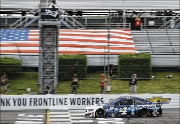  ?? MATT SLOCUM / AP ?? Kevin Harvick crosses the finish line Saturday after holding off Denny Hamlin to win the NASCAR Cup Pocono Organics 325 at Pocono Raceway. “That’s great to finally check Pocono off the list,” Harvick said.