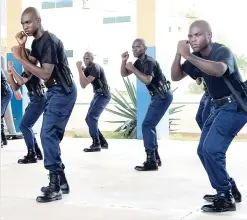  ?? IAN ALLEN/PHOTOGRAPH­ER ?? Policemen in combat mode during a demonstrat­ion of the Less Lethal Force Training and Defensive Tactics at the National Police College of Jamaica in Twickenham Park, Spanish Town, St Catherine, yesterday.