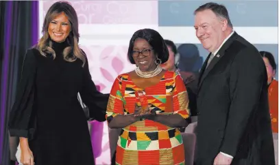  ?? Carolyn Kaster The Associated Press ?? Dr. Beauty Rita Nyampinga, of Zimbabwe, holds her award as she is flanked by first lady Melania Trump and Secretary of State Mike Pompeo during the 2020 Internatio­nal Women of Courage Award ceremony at the State Department on Wednesday.