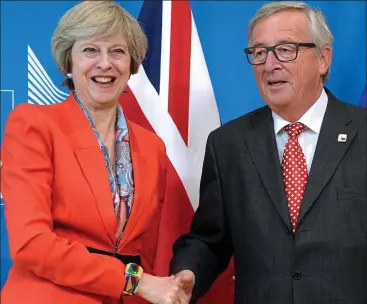  ??  ?? Agreement: Theresa May and European Commission President Jean Claude Juncker