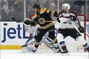  ?? MICHAEL DWYER - THE ASSOCIATED PRESS ?? Boston Bruins’ David Pastrnak (88) tries to deflect a shot past Colorado Avalanche goalie Pavel Francouz, behind, as Ian Cole (28) defends during the third period of an NHL hockey game in Boston, Saturday, Dec. 7, 2019.