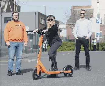  ??  ?? With one of the e-scooters are, rom left, Teddy Howard, Collette Dunkley and George Symes.