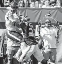  ??  ?? Browns cornerback Greg Newsome II, right, breaks up a pass intended for Texans receiver Brandin Cooks in the second half.