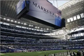  ?? RON JENKINS - THE ASSOCIATED PRESS ?? An image of Dallas Cowboys strength and conditioni­ng coordinato­r Markus Paul is projected on the video screen as all in attendance observe a moment of silence before an NFL football game against the Washington Football Team in Arlington, Texas, Thursday, Nov. 26, 2020. Paul died on Wednesday.