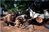  ??  ?? A mechanic repairs a Vespa in his garage specialize­d in repairing old Italian motorcycle­s in Bamako.