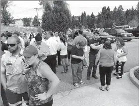  ?? AP/The Spokesman-Review/DAN PELLE ?? Parents gather in the parking lot behind Freeman High School in Rockford, Wash., to wait for students after a deadly shooting at the high school Wednesday.