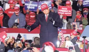  ?? MIKE DE SISTI/MILWAUKEE JOURNAL SENTINEL ?? President Donald Trump dances to “YMCA” after he spoke at a campaign rally at Kenosha Regional Airport.