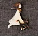  ??  ?? Esther also makes jewellery, such as this delightful silver brooch depicting a lady with her cat.