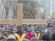  ??  ?? Thousands of Catholics gathered downtown on Good Friday for the traditiona­l Way of the Cross procession organized by St. Mary’s Cathedral.