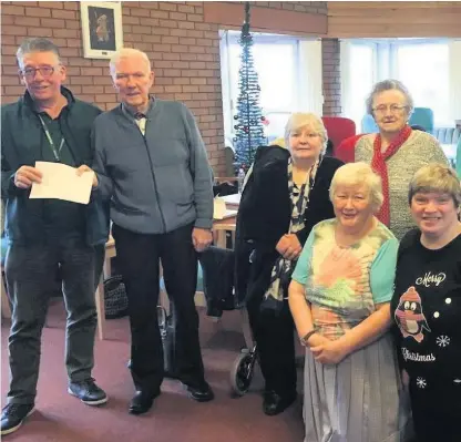  ?? ?? Community support Delighted Airdrie foodbank representa­tive Robert Jack, left, is pictured accepting the fantastic £470 donation from generous residents of John Smith Court during his visit to the Airdrie sheltered housing facility