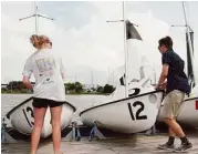  ??  ?? Amanda Bayet, 17, and Dane Byerly, 18, prepare for Clear Falls’ competitio­ns at Lakewood Yacht Club in Seabrook.