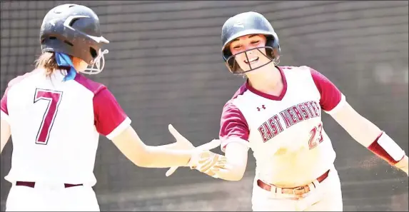  ?? ?? East Webster’s Keely Jo Mcknight (23) and Peyton Flora celebrate a run scoring during Wednesday’s game against Lake in game one of the Class 2A State championsh­ip series. (Photo by Bobby Mcduffie, MHSAA, for Starkville Daily News)