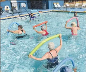  ?? (NWA Democrat-Gazette/Flip Putthoff) ?? Women exercise on Wednesday during a water aerobics class at the Gravette city pool.