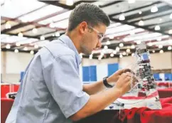  ??  ?? Hayden Settle, a Tennessee College of Applied Tech-Morristown student, participat­es in an aerospace engineerin­g competitio­n during Tuesday’s event.