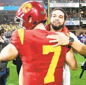  ?? MEG MCLAUGHLIN U-T ?? Sometimes going through the transfer portal makes sense, like when QB Caleb Williams, here hugging his backup Miller Moss (7), followed his coach from Oklahoma to USC.