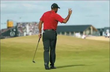  ?? PETER MORRISON — ASSOCIATED PRESS ?? Tiger Woods plays a shot to the 18th green during the final round of the British Open.