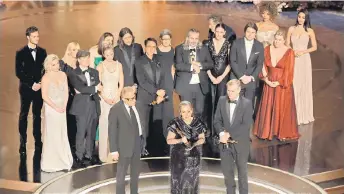 ?? — AFP photo ?? (From left) Jack Quaid, Florence Pugh, Ellen Mirojnick, Murphy, Emily Blunt, Ludwig Göransson, Charles Roven, Robert Downey Jr., Luisa Abel, Emma Thomas, Hoyte van Hoytema, Ruth De Jong, Nolan, Josh Hartnett, Ashley Everett and Claire Kaufman accept the Best Picture award for ‘Oppenheime­r’ onstage during the 96th Annual Academy Awards at Dolby Theatre in Hollywood, California.