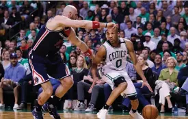  ?? — AP ?? Boston Celtics’ Avery Bradley drives to the basket against Washington Wizards Marcin Gortat in their NBA game on Wednesday.