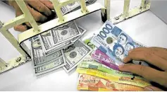  ?? —FILE PHOTO ?? A customer exchanges dollars for pesos. The peso last week sank to 53 against the US dollar, its weakest in about three and a half years.