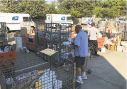  ?? Photos by Demian Bulwa / The Chronicle ?? Tens of thousands of parcels destined for delivery to the homes of Santa Rosa’s fire victims are instead piled in a back lot at a local post office.