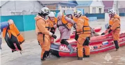  ?? | AFP ?? RESCUERS evacuate a resident in a water rescue boat during a flood in the town of Orsk, Orenburg region, southeast of the southern tip of the Ural Mountains in Russia.