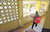  ?? ANSHUMAN POYREKAR/ HT ?? A staff disinfects a building in Prabhadevi, after a resident tested positive on Sunday.