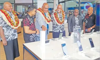  ?? Picture: VODAFONE FIJI ?? Vodafone Fiji acting CEO Rajnesh Prasad shows products on sale at the Vodafone Fiji Premium Nadi outlet to chief guest Minister for Trade and DPM Manoa Kamikamica, Tui Nadi Ratu Vuniani Navuniuci and Tui Nawaka Ratu Tomasi Kanailagi Naevo alongside other invited guests during the opening of the new branch.