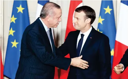  ??  ?? French President Emmanuel Macron, right, and Turkish President Recep Tayyip Erdogan during a joint press conference at the Elysee Palace in Paris on Friday. (AFP)