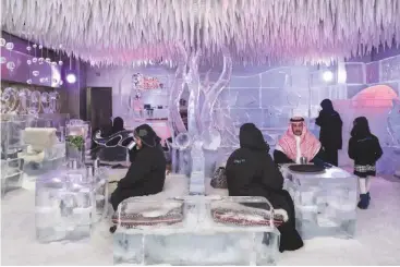  ?? Nikon D810, 24-70mm, 1/25sec at f/8, ISO 640 ?? Below: Saudi tourists having hot chocolate at the Chillout Ice Lounge, a subzero bar with ice sculptures
