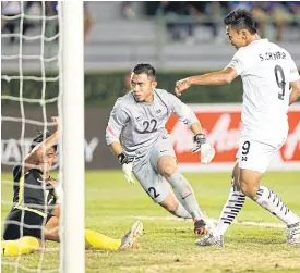  ??  ?? Thailand striker Chenrop Samphaodi, No.9, scores against Malaysia.