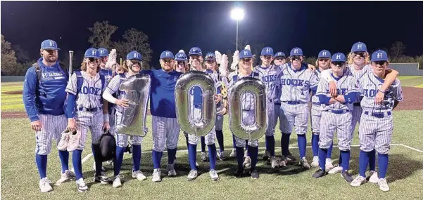  ?? (Submitted photo) ?? The Hooks Hornets baseball team pose for a photo Wednesday after defeating Redwater, 12-0, in Hooks, Texas. WIth the win, head coach Tony Hight recorded his 100th victory.