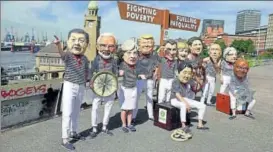  ?? AFP PHOTO ?? Activists wearing masks featuring world leaders including (LR) China's President Xi Jinping, India's Prime Minister Narendra Modi and Britain's PM Theresa May demonstrat­e at Hamburg.