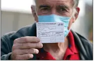  ?? (AP/Marcio Jose Sanchez) ?? Dr. Michael Roach, a specialist in internal medicine and geriatrics, shows his vaccinatio­n card Wednesday at a site for health care workers at Ritchie Valens Recreation Center in Pacoima, Calif. More photos at arkansason­line.com/114vaccine/.