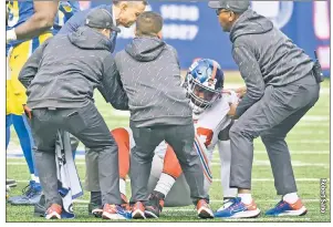  ?? ?? THIS HURTS! Andrew Thomas, who was placed on injured reserve Tuesday, is helped up after injuring his ankle during the Giants’ loss to the Rams on Sunday.