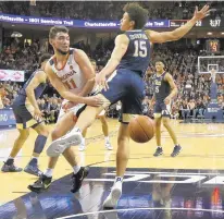  ?? STEVE HELBER/ASSOCIATED PRESS ?? Virginia guard Ty Jerome passes the ball around Pittsburgh forward Kene Chukwuka. Jerome’s target was Jack Salt, not shown.