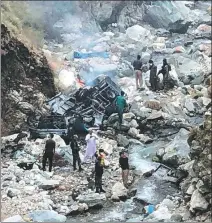  ?? AFP ?? Security officials inspect the wreckage of a vehicle that plunged into a ravine off the mountainou­s Karakoram Highway after a suicide bombing in Khyber Pakhtunkhw­a province in Pakistan on Tuesday. Five Chinese nationals were killed in the attack.