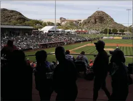  ?? DARRON CUMMINGS — THE ASSOCIATED PRESS ?? Fans watch a spring training game between the Angels and Padres on Feb. 27in Tempe, Ariz.