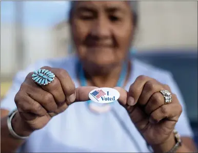  ?? AP PHOTO/CAYLA NIMMO, FILE ?? Mildred James of Sanders, Arizona, shows off her “I Voted” sticker as she awaits election results on Aug. 28, 2018, in Window Rock, Arizona, on the Navajo Nation.