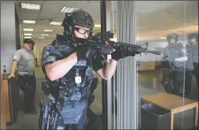  ?? BEA AHBECK/NEWS-SENTINEL ?? Officer Dominic Carillo enters a room during the Lodi Police Department’s SWAT training at the former General Mills plant in Lodi on Wednesday.