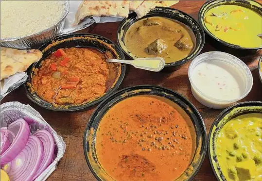  ?? Photos by Susie Davidson Powell / For the Times Union ?? A spread of takeout containers shows the array of poissibili­ties at Indian Flame in Wynantskil­l.