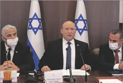  ?? GIL COHEN-MAGEN/POOL VIA AP ?? Israeli Prime Minister Naftali Bennett (center) chairs a weekly cabinet meeting, at the prime minister’s office in Jerusalem, on Sunday.