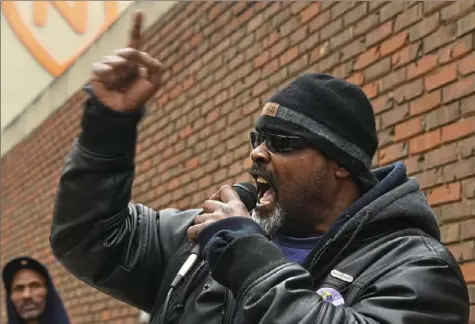  ?? Darrell Sapp/Post-Gazette ?? Steve Kelly, a member of the executive board of Service Employees Internatio­nal Union 32BJ, leads the crowd at a rally Friday in support of commercial office cleaners who, he says, were not retained after Checklist Facility Maintenanc­e took over maintenanc­e work at Nova Place on the North Side.